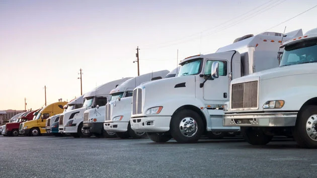 Commercial trucks lined up in a fleet yard