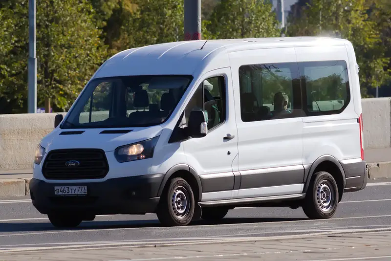 White Ford Transit work van on the road