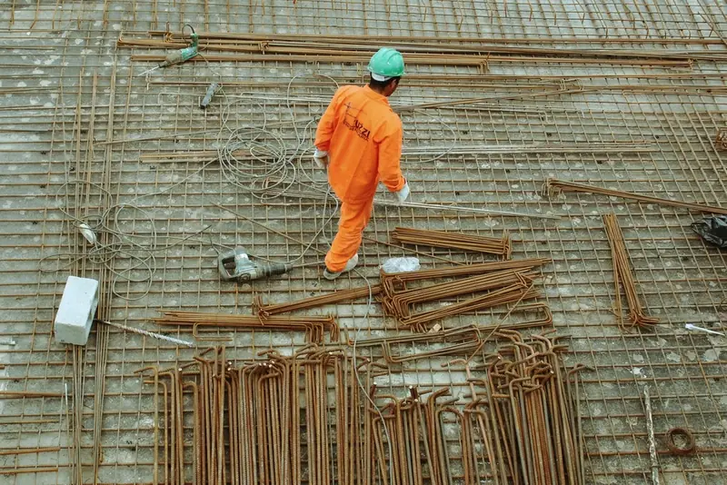 Construction worker tying rebar on a job site